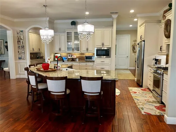 a kitchen with a stove top oven and refrigerator
