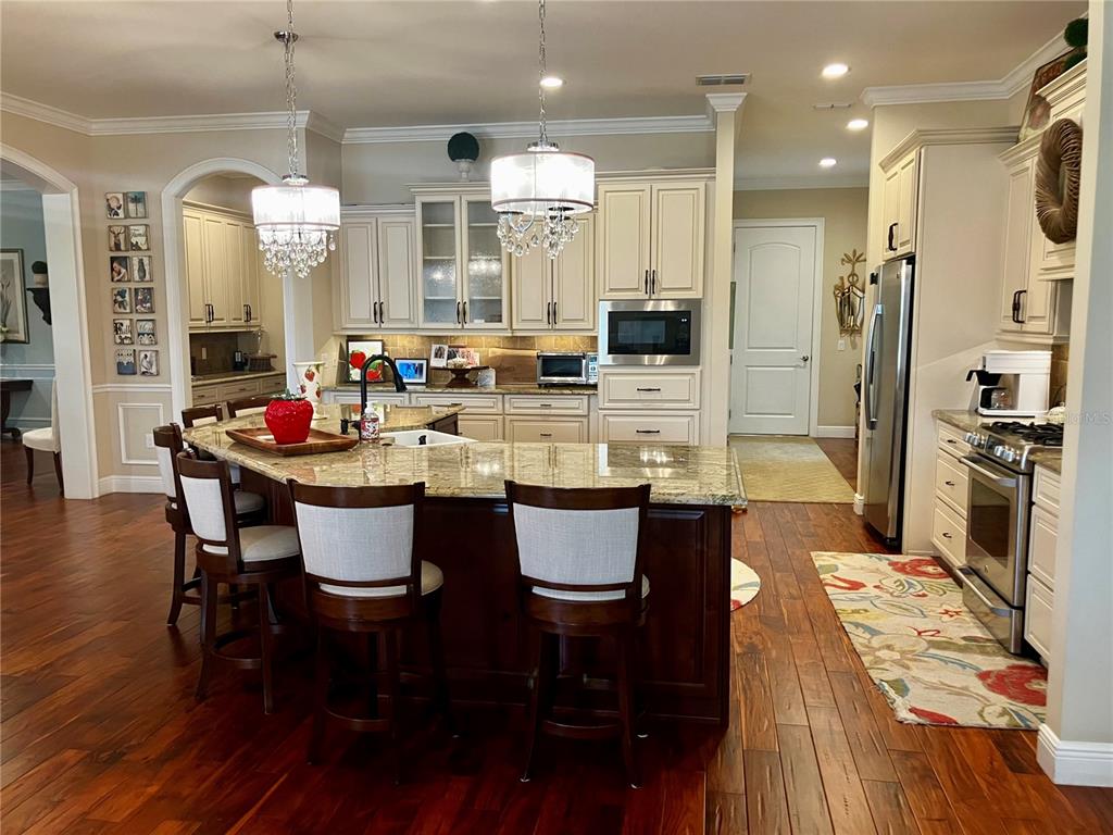 3709 Gallagher Road Plant City, FL 33565 - Photo 16 of 60 a large kitchen with a table and chairs