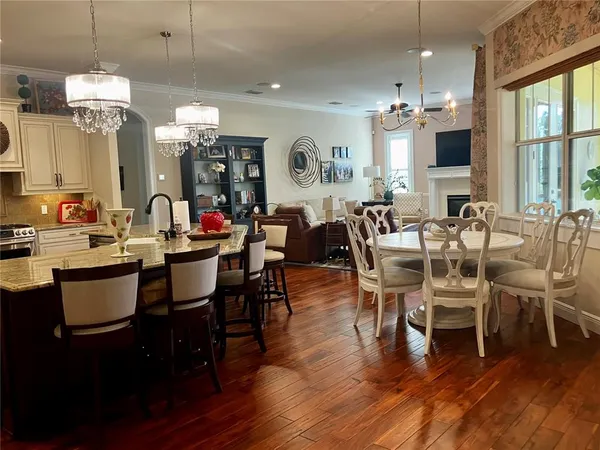 a room with a chandelier furniture a flat screen tv and a chandelier