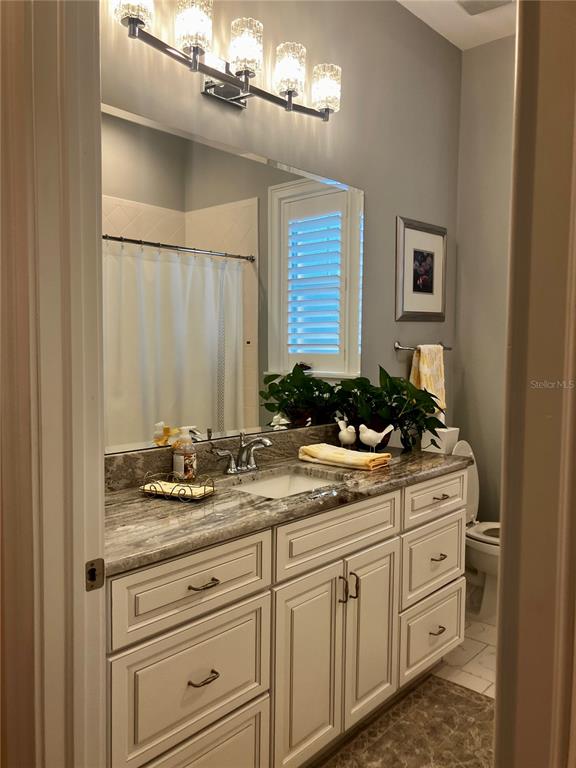3709 Gallagher Road Plant City, FL 33565 - Photo 33 of 60 a bathroom with a granite countertop sink and a mirror