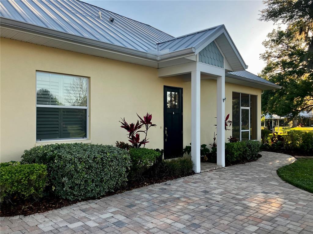 3709 Gallagher Road Plant City, FL 33565 - Photo 42 of 60 a view of a house with potted plants and a bench