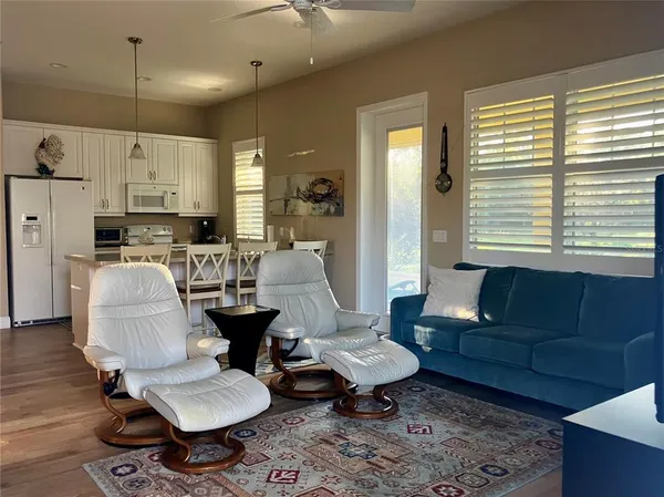 a view of a porch with furniture and a yard