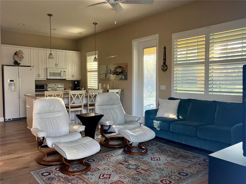 3709 Gallagher Road Plant City, FL 33565 - Photo 47 of 60 a living room with furniture couches and a dining table with wooden floor