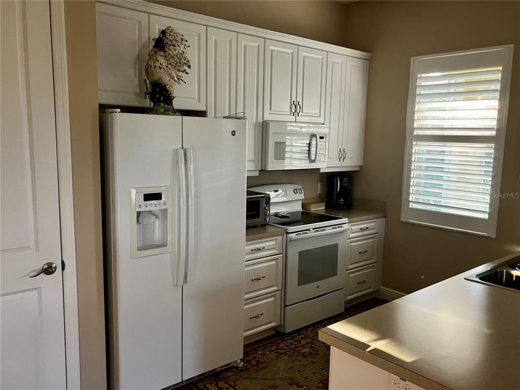 3709 Gallagher Road Plant City, FL 33565 - Photo 49 of 60 a kitchen with stainless steel appliances granite countertop a refrigerator and a stove