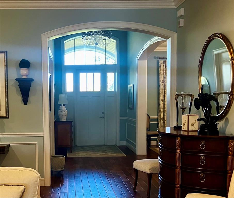 3709 Gallagher Road Plant City, FL 33565 - Photo 6 of 60 a living room with a mirror and a wooden floor