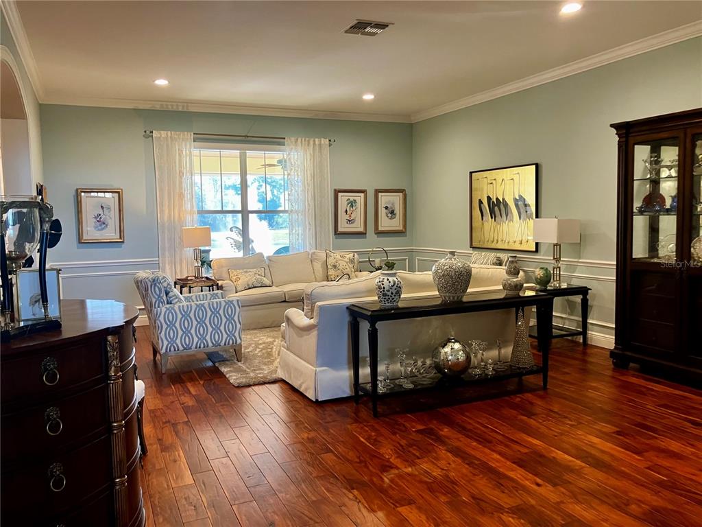 3709 Gallagher Road Plant City, FL 33565 - Photo 8 of 60 a living room with furniture and wooden floor