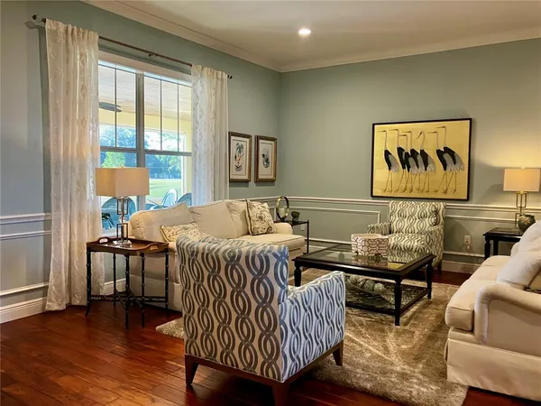 a living room with furniture and wooden floor