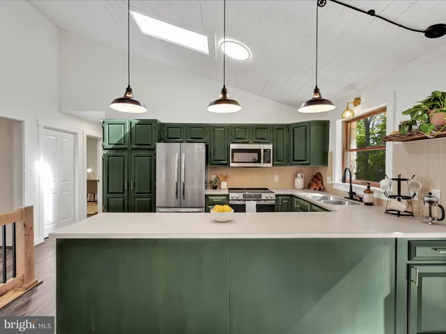 a kitchen with a sink a counter and chairs