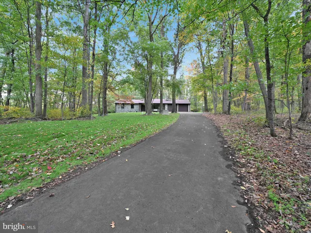 a view of a street with a house in the background
