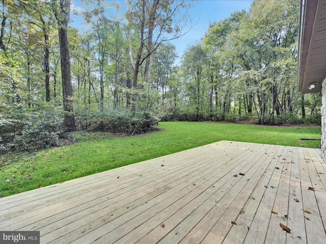 a view of an outdoor space and deck with yard