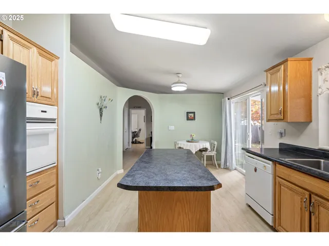 a kitchen view with appliances and cabinets