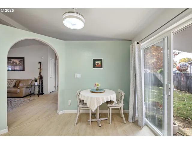 a dining room with furniture and wooden floor