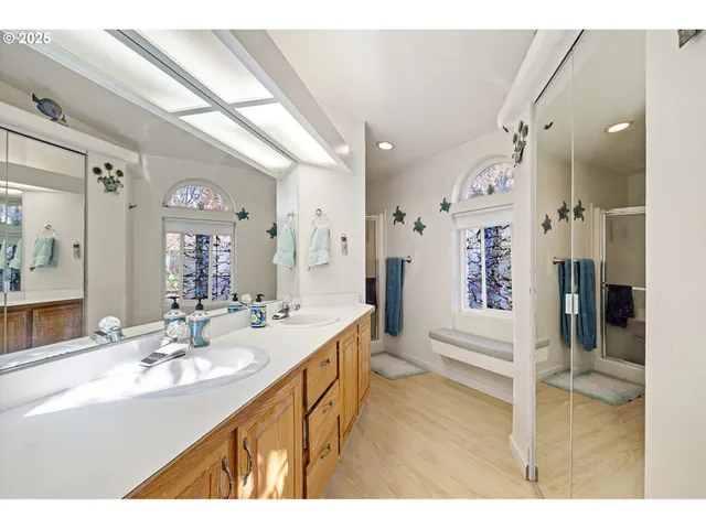 a bathroom with a sink a mirror and a shower