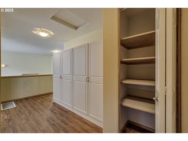 a view of walk in closet with empty racks