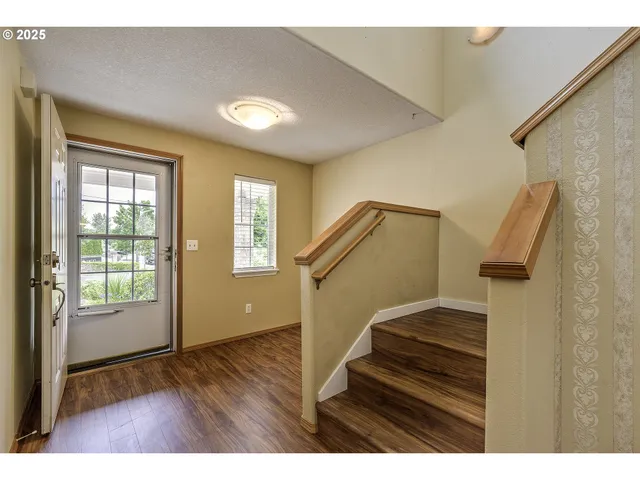 a view of entryway and hall with wooden floor