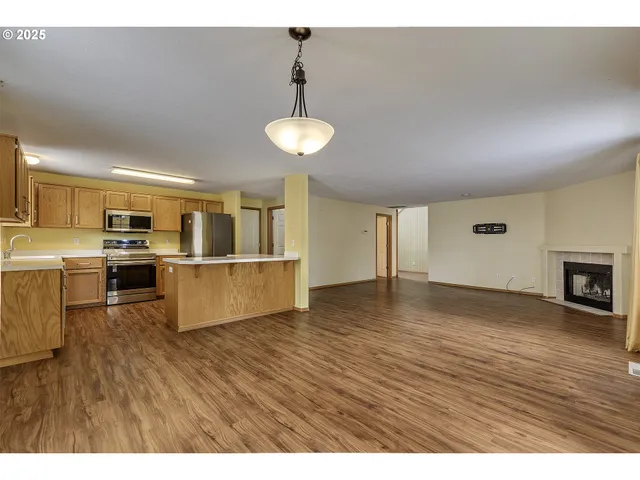 a view of kitchen with furniture and wooden floor