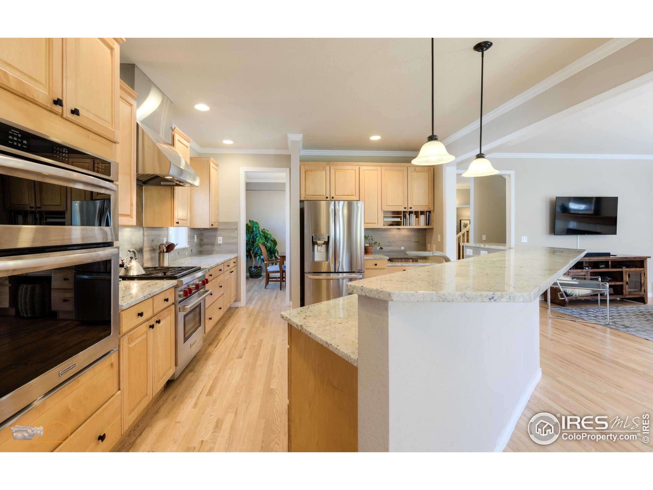 4921 Fountain Street Boulder, CO 80304 - Photo 7 of 50 a large kitchen with stainless steel appliances kitchen island granite countertop a large kitchen island a stove and a sink