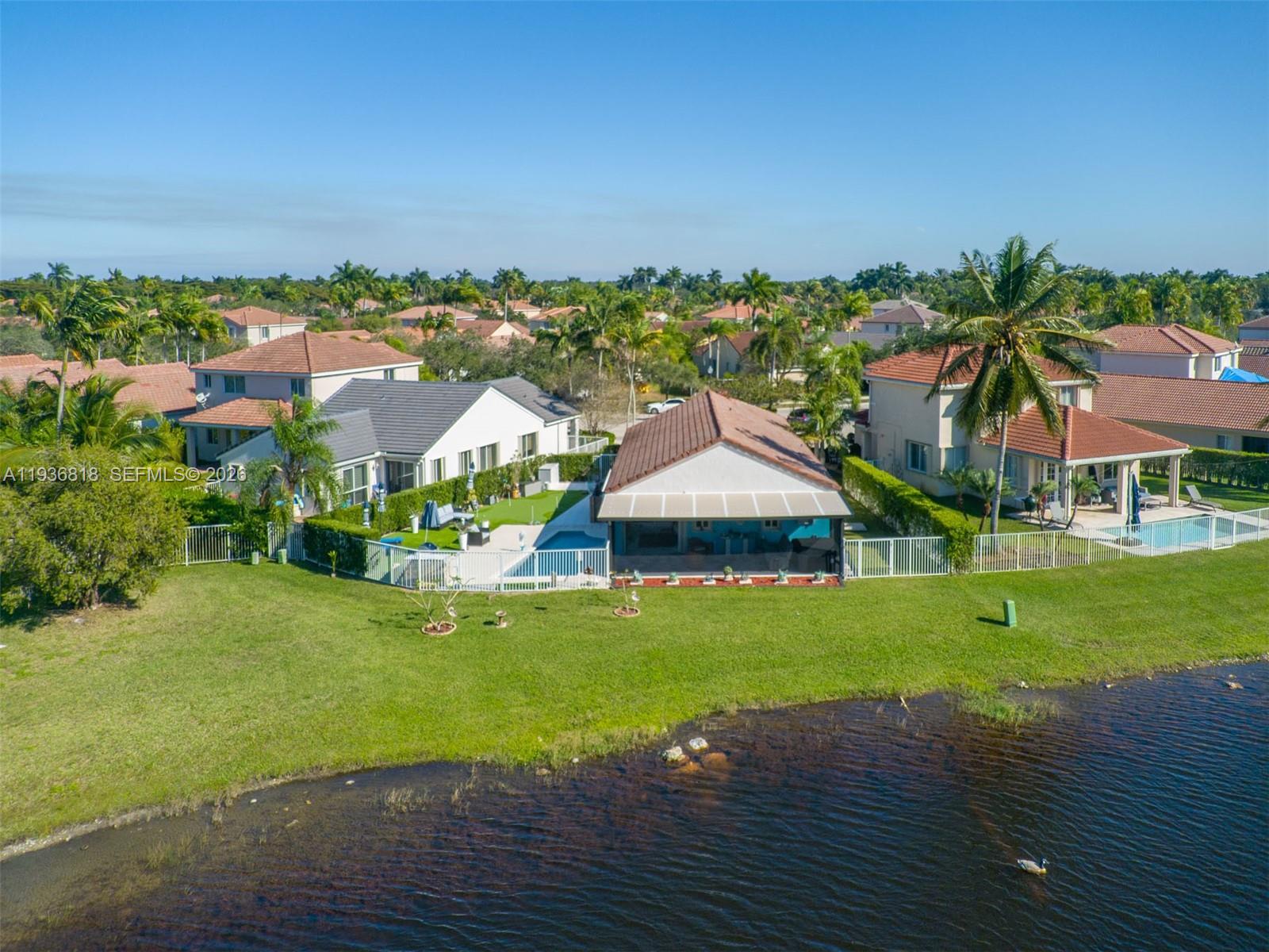 1409 Majesty Terrace Weston, FL 33327 - Photo 13 of 61 an aerial view of a house with swimming pool garden and lake view