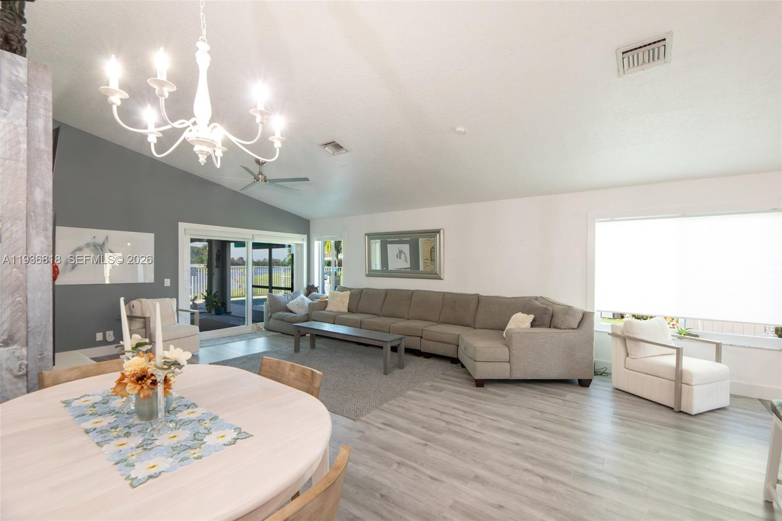 1409 Majesty Terrace Weston, FL 33327 - Photo 18 of 61 a living room with furniture kitchen view and a large window