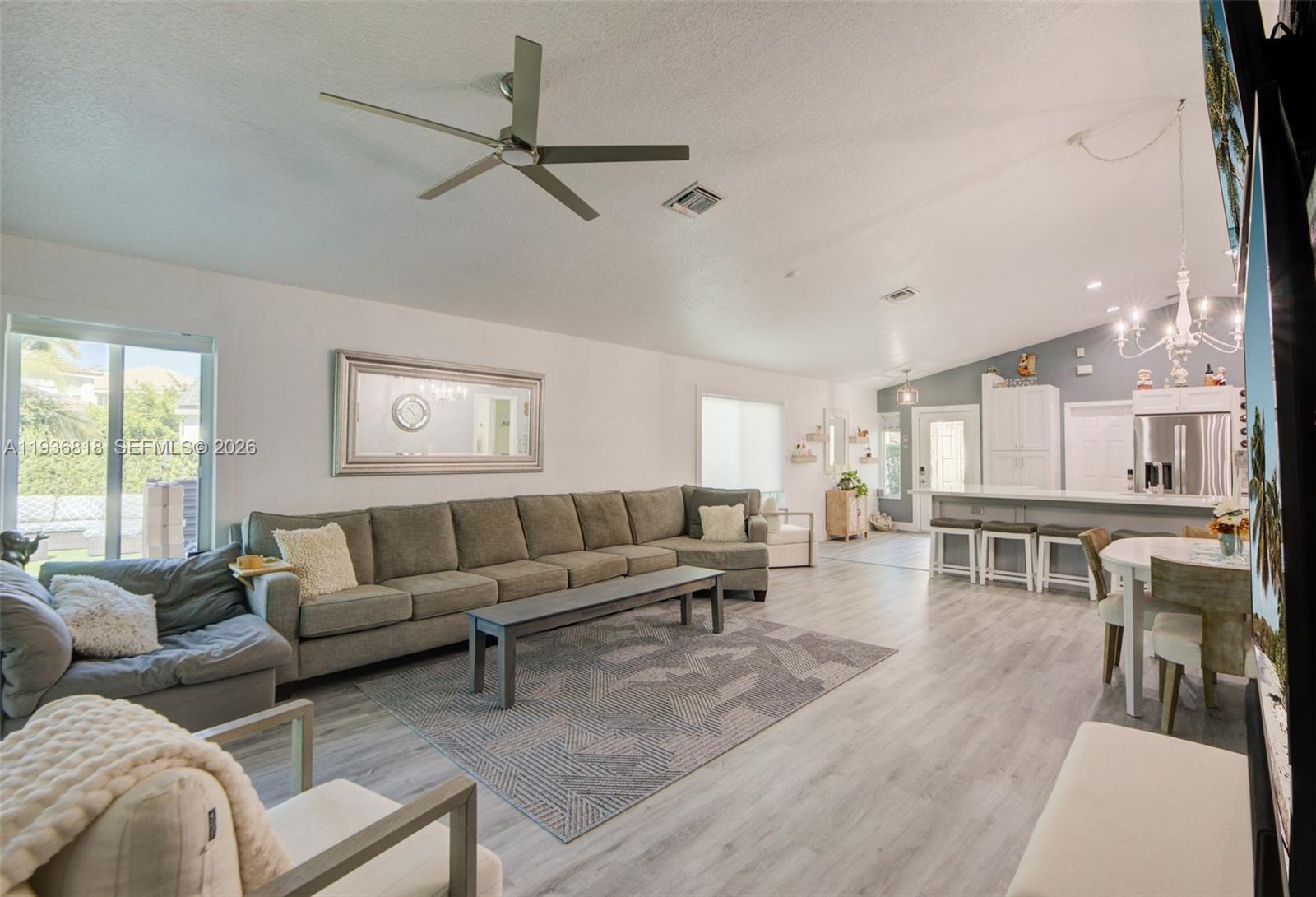 1409 Majesty Terrace Weston, FL 33327 - Photo 20 of 61 a living room with furniture and a window