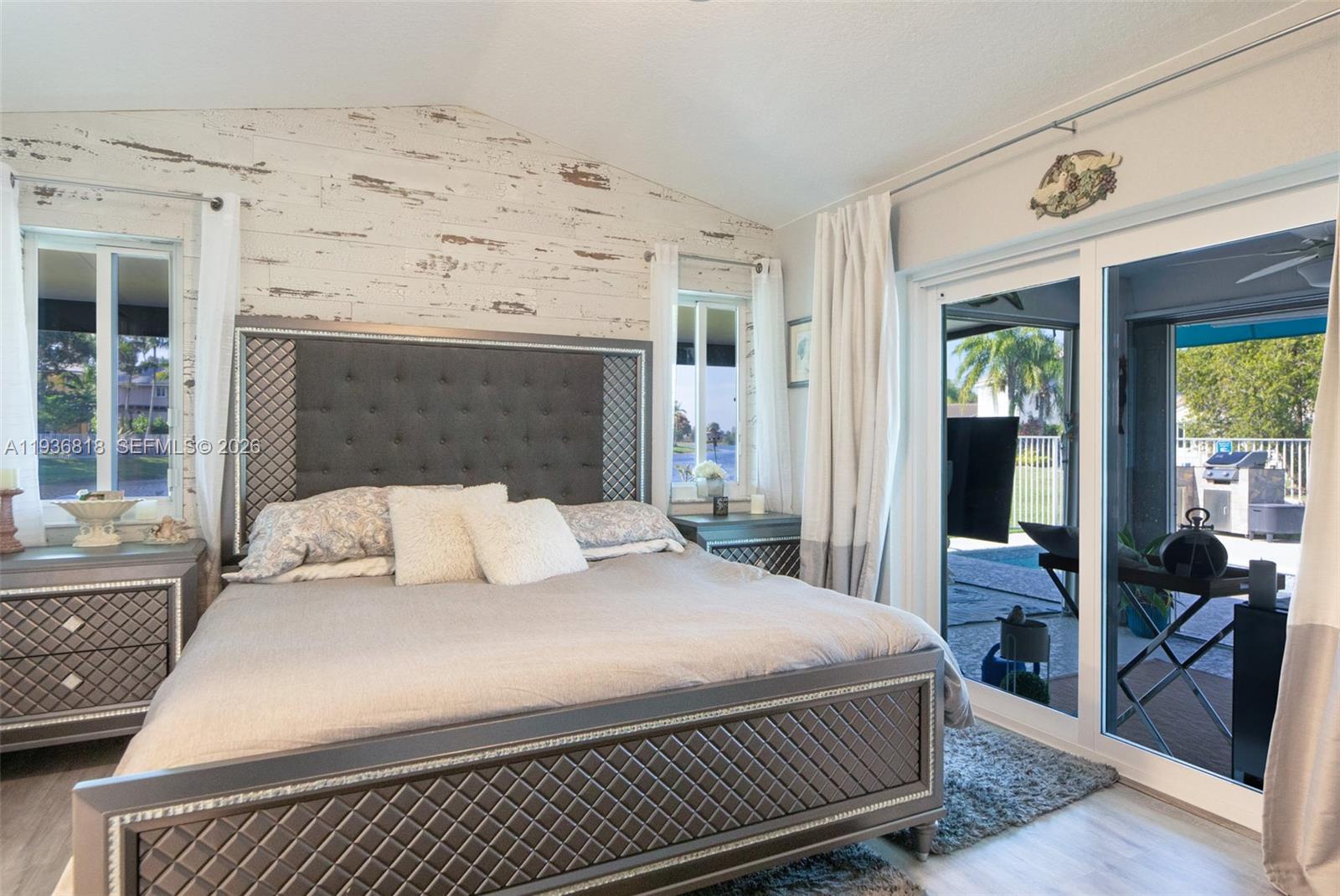 1409 Majesty Terrace Weston, FL 33327 - Photo 28 of 61 a bedroom with a large bed and a fireplace