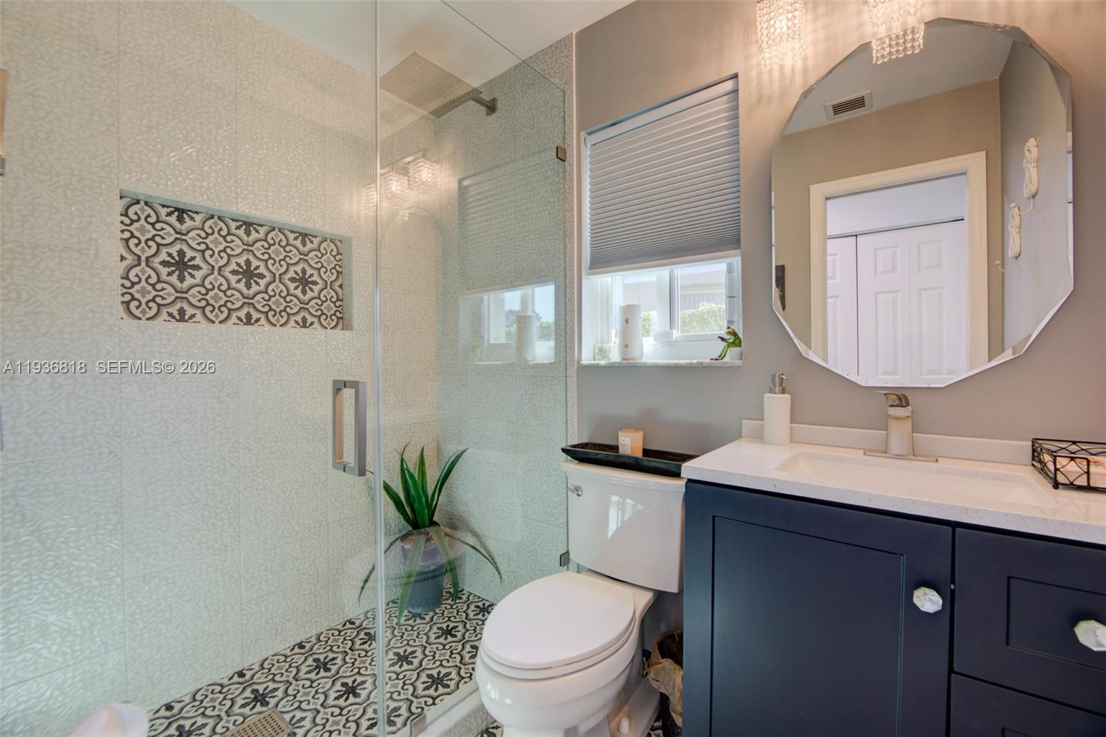 1409 Majesty Terrace Weston, FL 33327 - Photo 36 of 61 a bathroom with a toilet a sink a mirror a vanity and shower