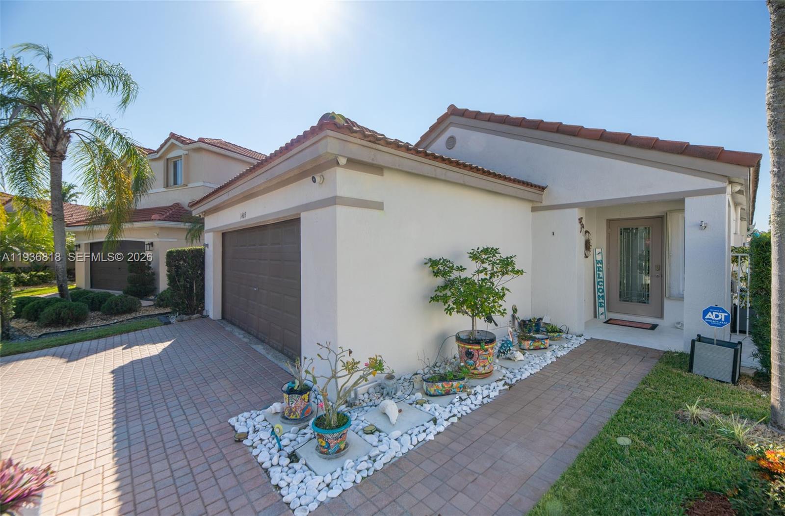 1409 Majesty Terrace Weston, FL 33327 - Photo 4 of 61 a front view of a house with a yard