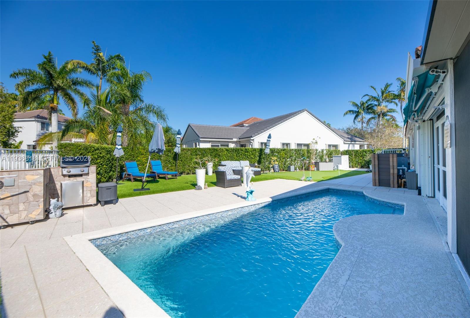 1409 Majesty Terrace Weston, FL 33327 - Photo 47 of 61 a view of a house with swimming pool and sitting area