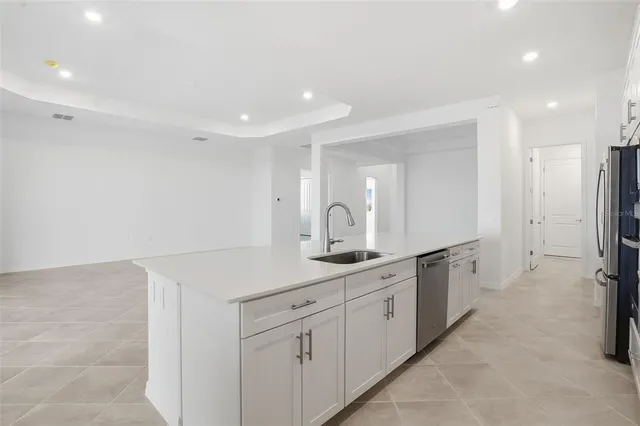a spacious bathroom with a double vanity sink toilet mirror and bathtub