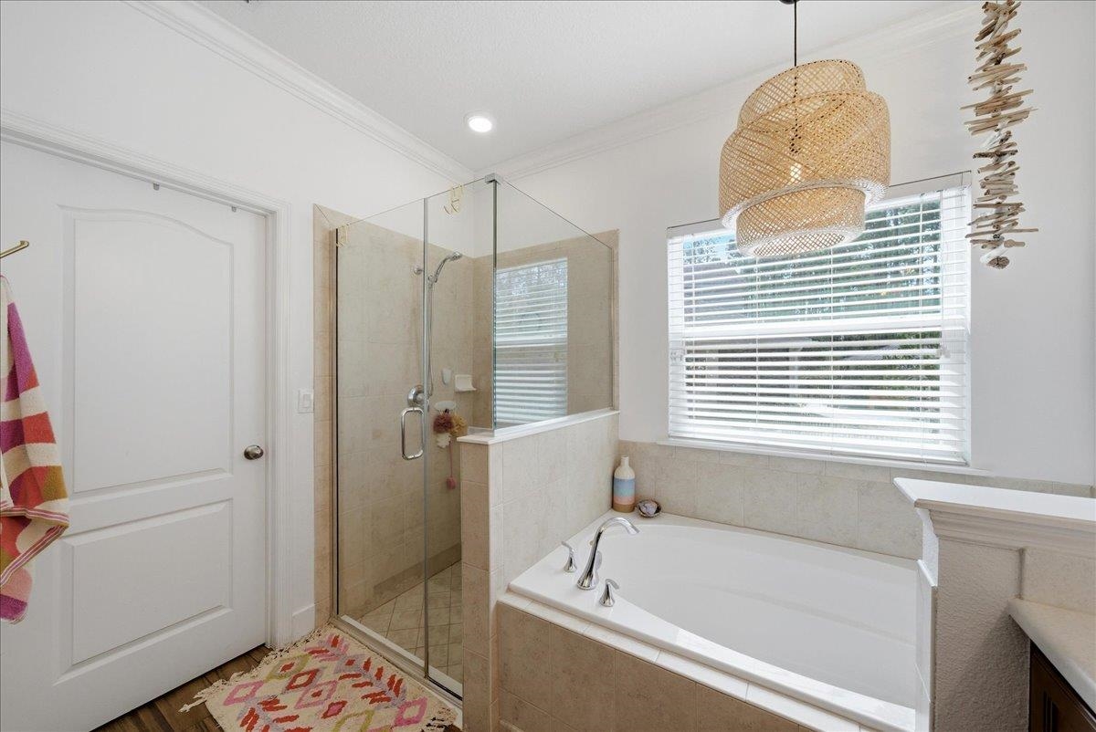 110 Ceja Way St. Augustine, FL 32095 - Photo 17 of 78 a bathroom with a bathtub a shower and a window