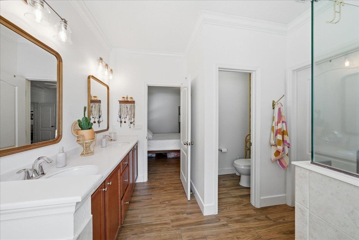 110 Ceja Way St. Augustine, FL 32095 - Photo 18 of 78 a bathroom with a sink and mirror with toilet