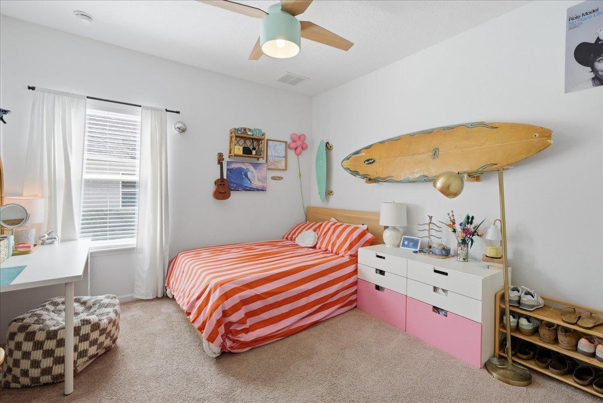 110 Ceja Way St. Augustine, FL 32095 - Photo 21 of 78 a bedroom with a bed and a chandelier