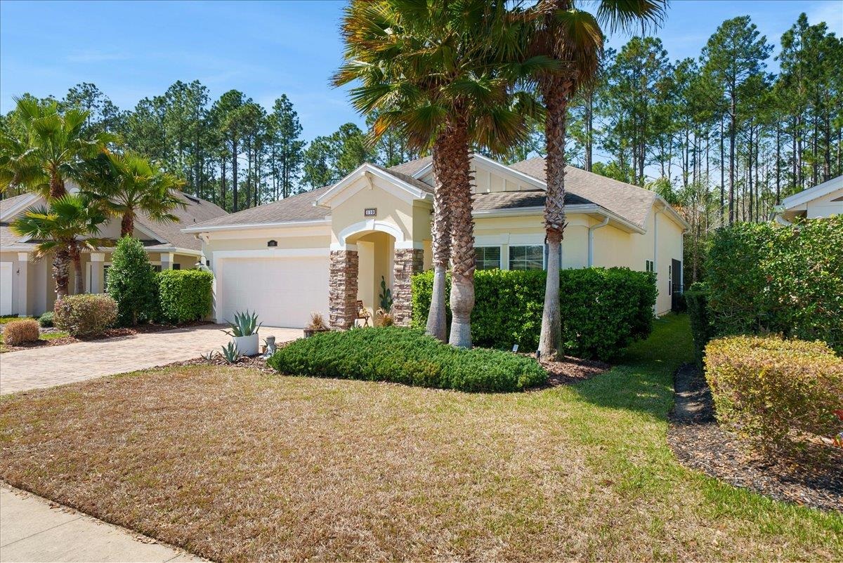 110 Ceja Way St. Augustine, FL 32095 - Photo 41 of 78 a front view of a house with a garden