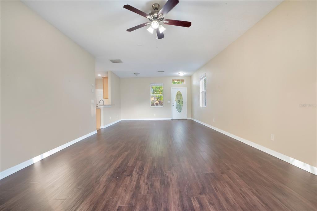 15031 Skip Jack Loop Lakewood Ranch, FL 34202 - Photo 5 of 27 a view of wooden floor and a chandelier fan in a room