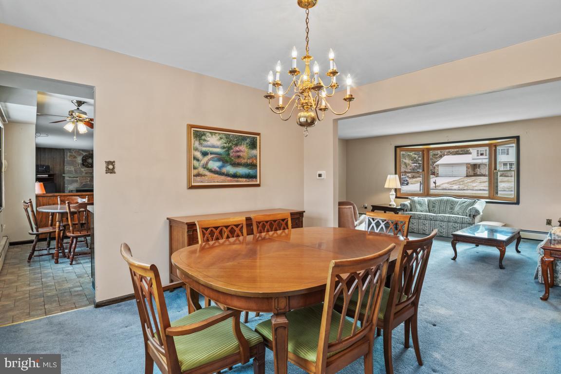 29 Holly Hill Road Richboro, PA 18954 - Photo 11 of 40 a dining room with furniture a chandelier and window