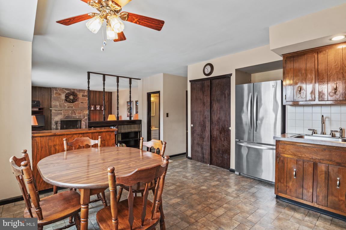29 Holly Hill Road Richboro, PA 18954 - Photo 14 of 40 a dining room with stainless steel appliances granite countertop a dining table and chairs with wooden floor