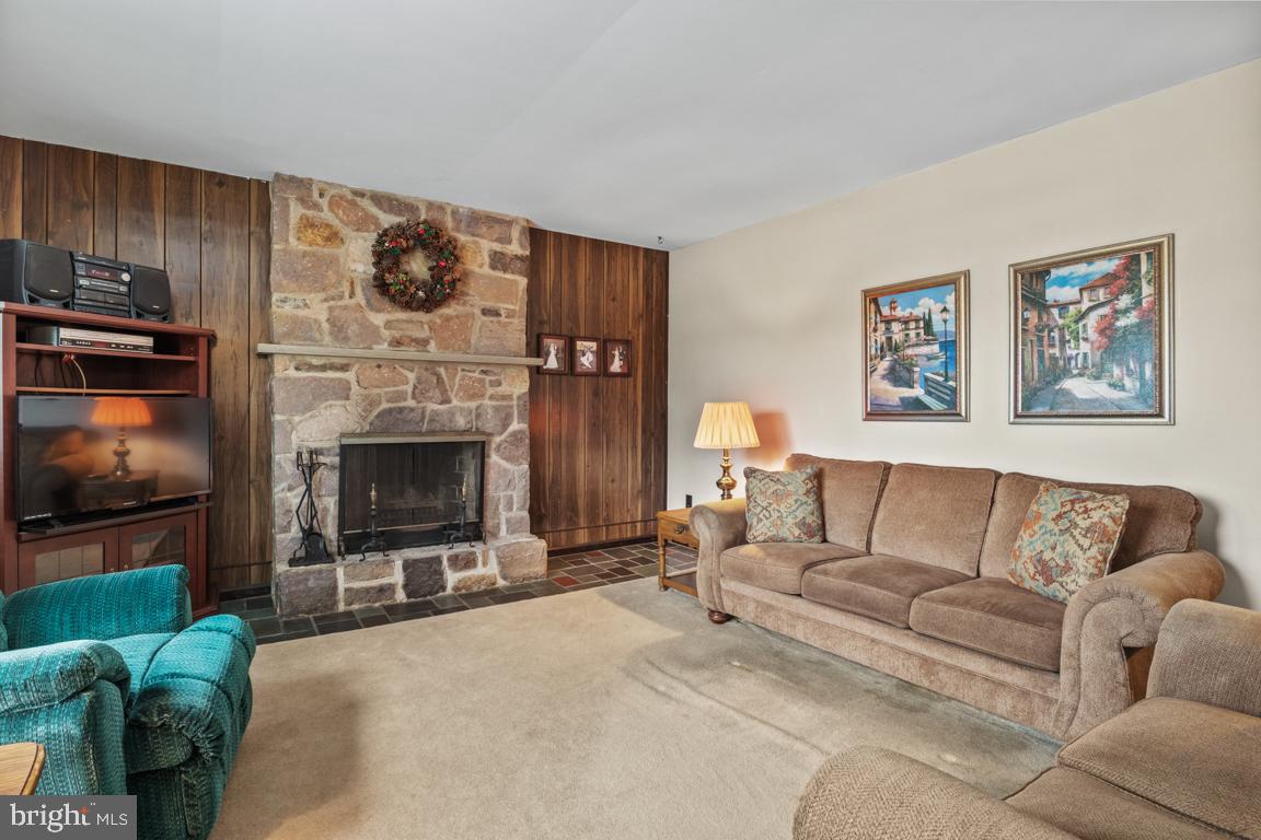 29 Holly Hill Road Richboro, PA 18954 - Photo 16 of 40 a living room with furniture a flat screen tv and a fireplace
