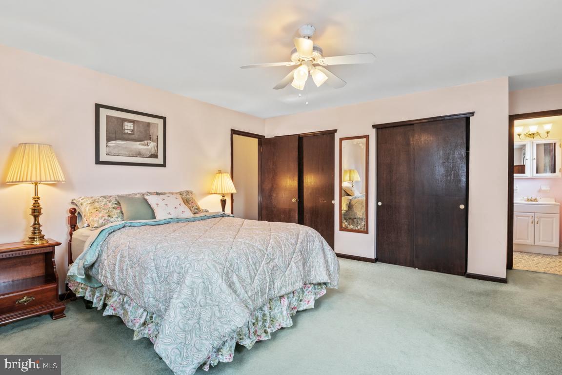29 Holly Hill Road Richboro, PA 18954 - Photo 24 of 40 a spacious bedroom with a bed and a chandelier