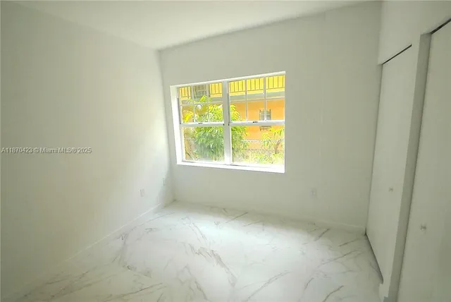 a view of a brick building next to a yard