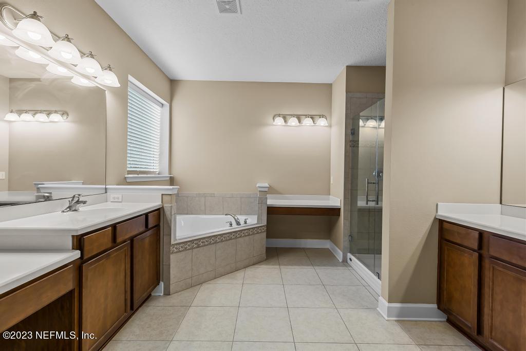 126 Arabian Court St. Augustine, FL 32095 - Photo 16 of 62 a bathroom with a tub sink and mirror