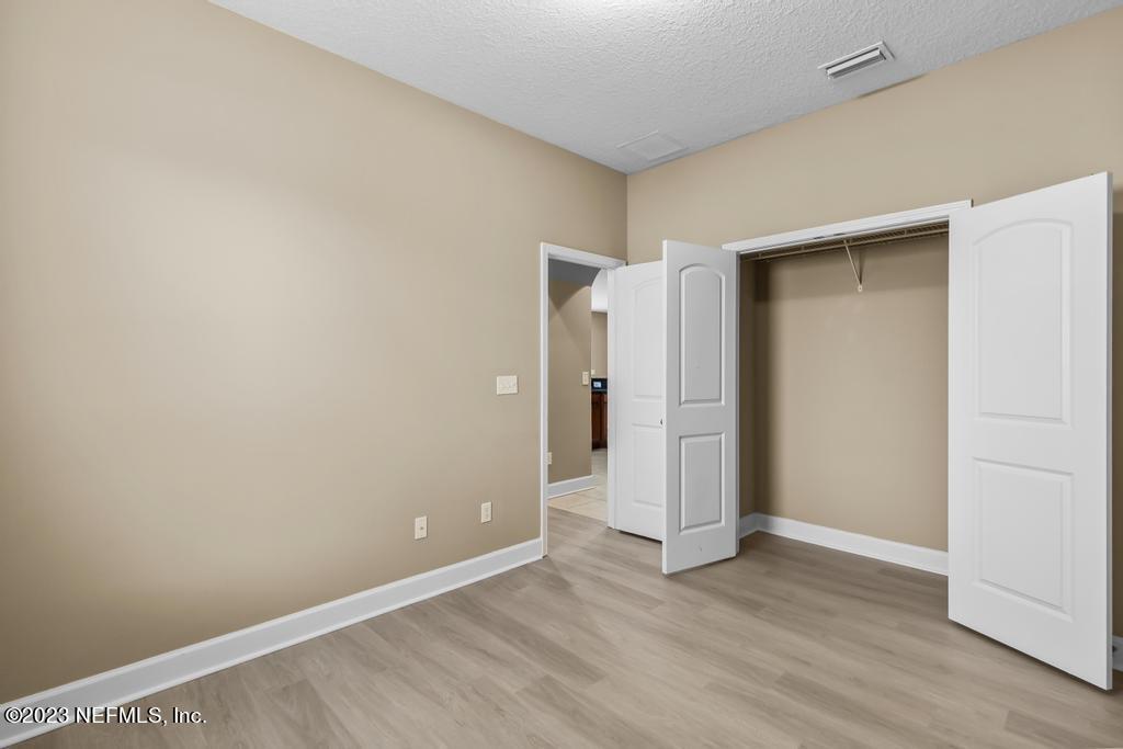 126 Arabian Court St. Augustine, FL 32095 - Photo 22 of 62 an empty room with wooden floor and closet