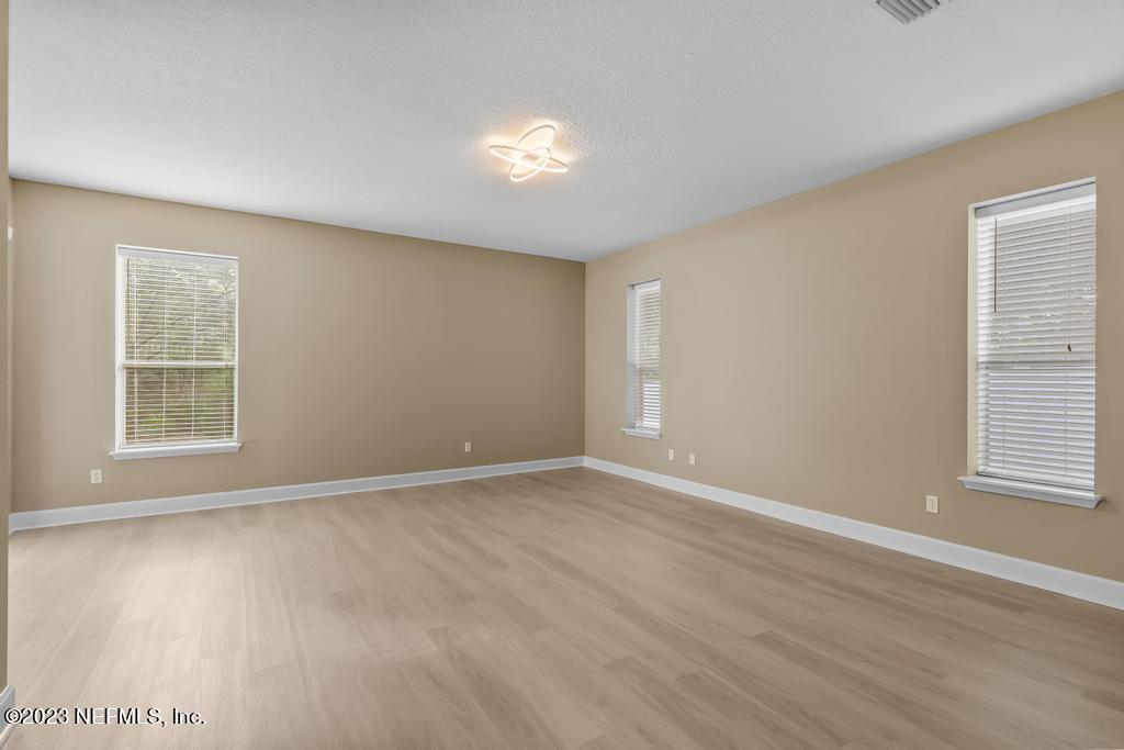 126 Arabian Court St. Augustine, FL 32095 - Photo 51 of 62 an empty room with wooden floor and windows