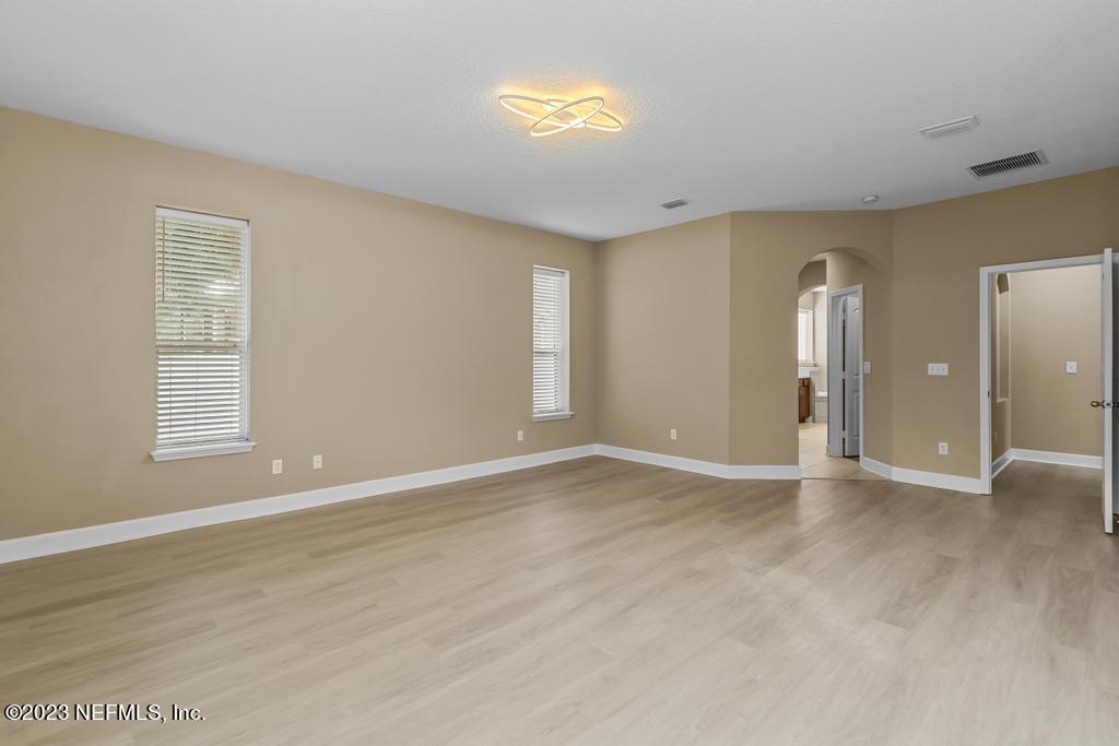 126 Arabian Court St. Augustine, FL 32095 - Photo 52 of 62 an empty room with wooden floor and windows