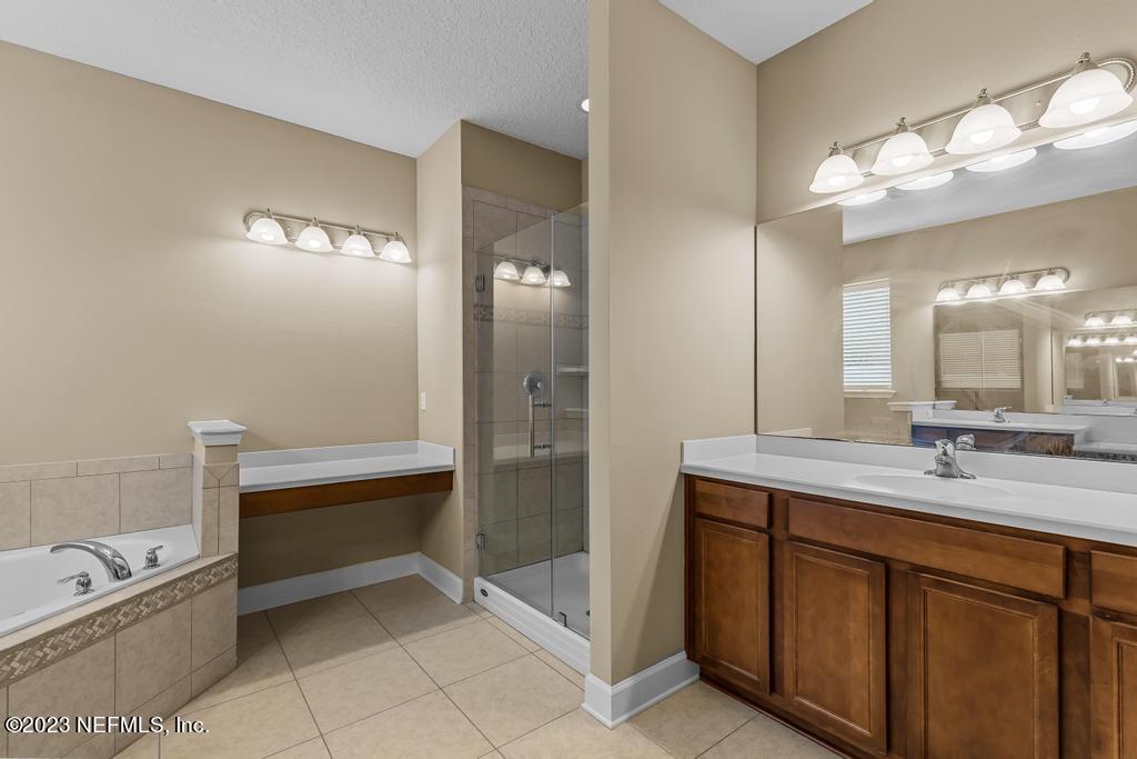 126 Arabian Court St. Augustine, FL 32095 - Photo 56 of 62 a bathroom with a tub a sink and a mirror