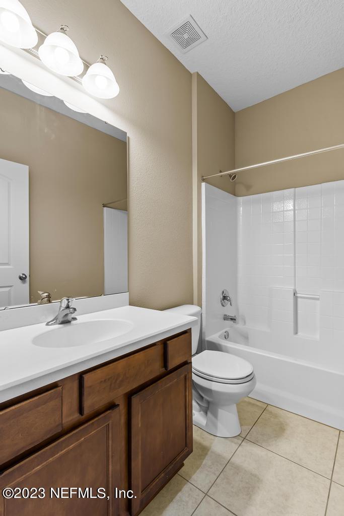 126 Arabian Court St. Augustine, FL 32095 - Photo 60 of 62 a bathroom with a sink a toilet and a mirror