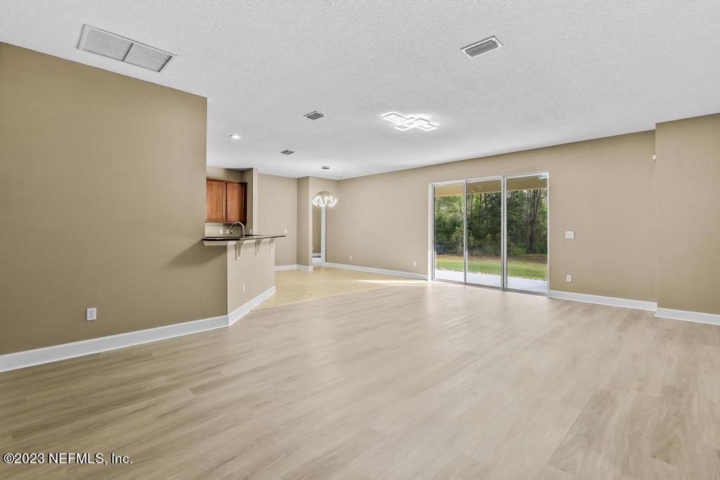 126 Arabian Court St. Augustine, FL 32095 - Photo 9 of 62 a view of an empty room with wooden floor and a window