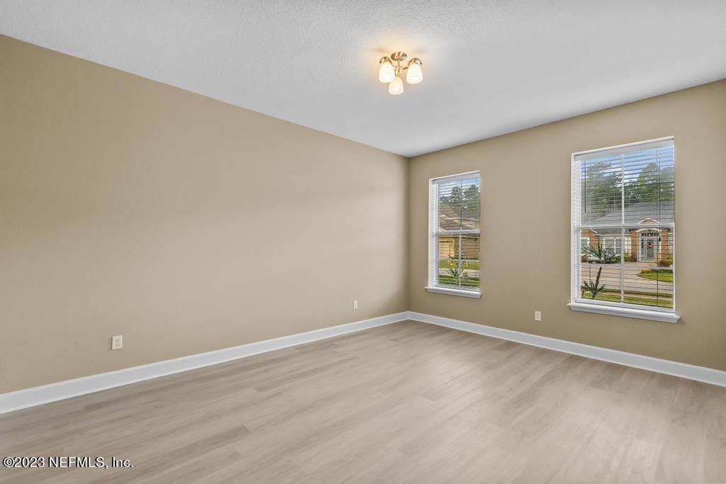 126 Arabian Court St. Augustine, FL 32095 - Photo 10 of 62 a view of an empty room with a window and wooden floor