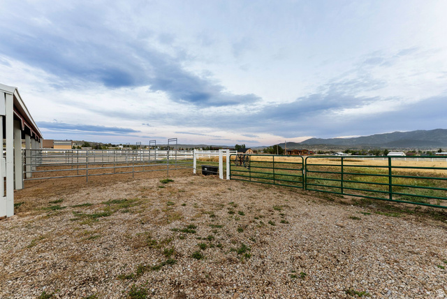 8650 Redden Road Park City, UT 84098 - Photo 40 of 71 Expansive outdoor area featuring a gravel ground, green pasture beyond, and fencing