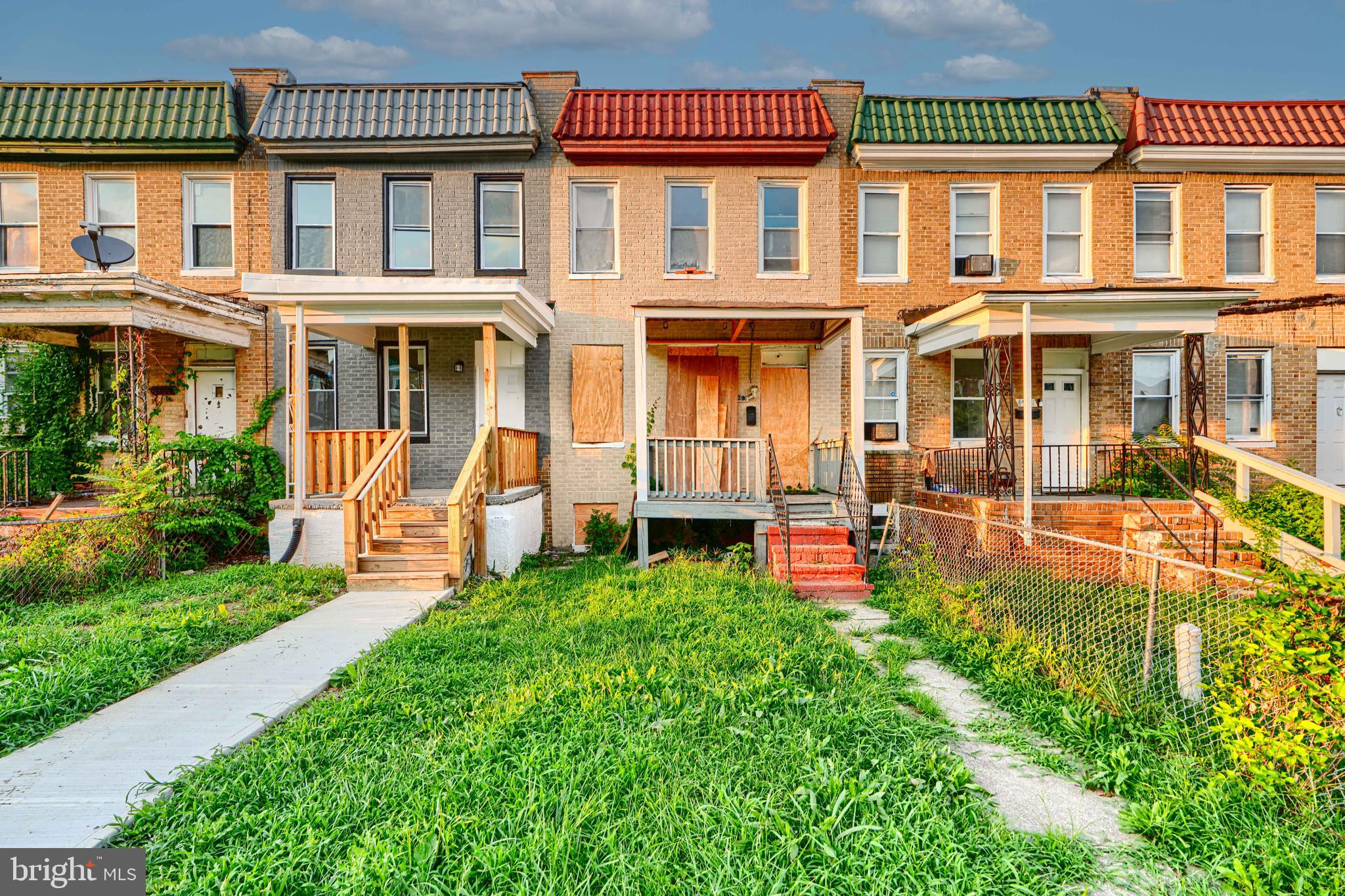 4963 Edgemere Avenue Baltimore, MD 21215 - Photo 1 of 3 front view of a house with a yard