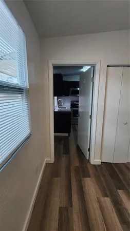 a view of hallway with wooden floor